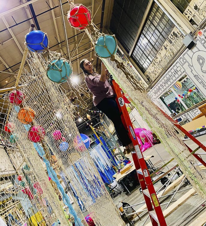 Melissa Moon adds the final touches to her Seaworthy Signpost, let them help you find your way